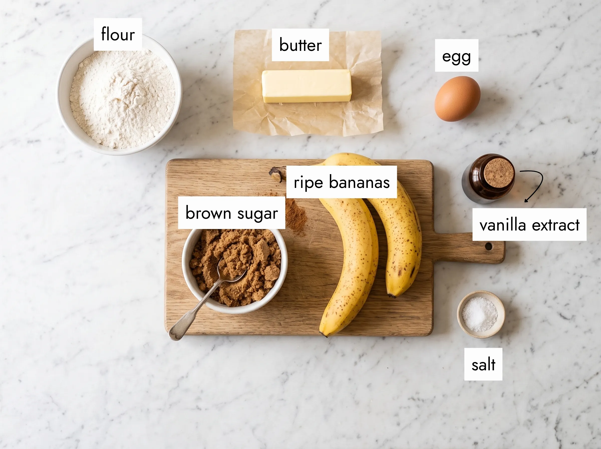 Flat lay of banana blondies ingredients — ripe bananas, brown sugar, butter, flour, egg on white marble