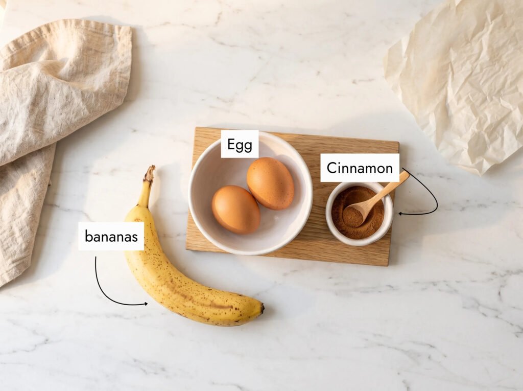 ingredients for banana pancakes for baby on marble — ripe banana, two eggs, ground cinnamon