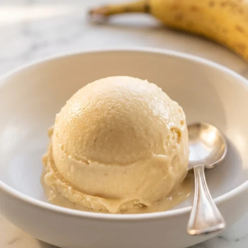 Close-up of banana nice cream soft serve texture in white bowl, silky and naturally sweet